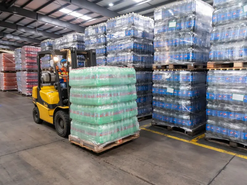 Forklift carrying pallets in the warehouse