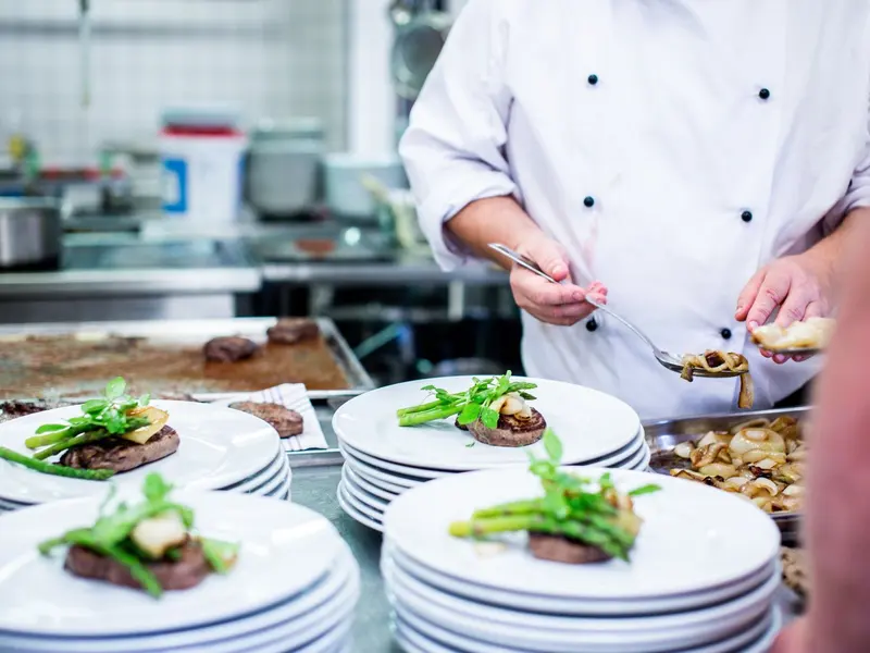 Chef plating dishes on the line