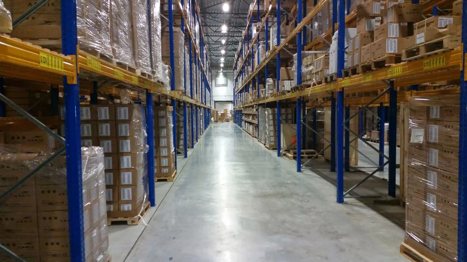 Long warehouse aisle with racked pallets